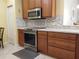 Modern kitchen featuring stainless steel appliances and granite countertops at 1649 Linz Ct, Winter Haven, FL 33884