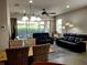 Open living and dining space with tile floors and comfortable furniture at 1649 Linz Ct, Winter Haven, FL 33884