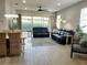 Spacious living room with tile floors, leather sofas, and dining area at 1649 Linz Ct, Winter Haven, FL 33884