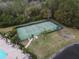 Community tennis court with surrounding trees and greenery at 1649 Linz Ct, Winter Haven, FL 33884