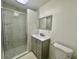 Well-lit bathroom features a glass shower, modern vanity, and sleek mirror at 1663 W Lake Cannon Nw Dr, Winter Haven, FL 33881