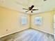 Bright bedroom with new flooring, ceiling fan, and natural light at 1663 W Lake Cannon Nw Dr, Winter Haven, FL 33881