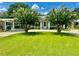 Attractive single-story home with well-manicured lawn and mature landscaping at 1663 W Lake Cannon Nw Dr, Winter Haven, FL 33881