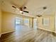 Spacious living area with light walls, wood-look flooring, and ceiling fans at 1663 W Lake Cannon Nw Dr, Winter Haven, FL 33881