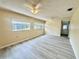 Large, sunny living room with laminate floors and plenty of space at 1663 W Lake Cannon Nw Dr, Winter Haven, FL 33881