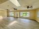 Spacious living area with light walls, vinyl flooring, and multiple ceiling fans at 1663 W Lake Cannon Nw Dr, Winter Haven, FL 33881