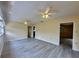 Bright living room with wood-look floors and ceiling fans at 1663 W Lake Cannon Nw Dr, Winter Haven, FL 33881