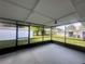Enclosed screened patio with overhead light fixture, offering indoor-outdoor living at 1663 W Lake Cannon Nw Dr, Winter Haven, FL 33881