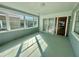 Bright sunroom with multiple windows, tiled floors, and access to the outside at 1663 W Lake Cannon Nw Dr, Winter Haven, FL 33881