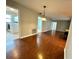 Spacious living area with wood-look flooring and access to laundry at 2024 Kapree Ct, Winter Haven, FL 33884