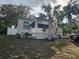 Cute bungalow with white porch and palm trees at 205 Maple W St, Davenport, FL 33837