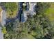 An aerial view showcasing a home's roofline, driveway, and surrounding trees at 2300 N Scenic Hwy # 37, Lake Wales, FL 33853