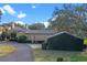 Exterior view of a charming home with a tile roof and lush landscaping at 2300 N Scenic Hwy # 37, Lake Wales, FL 33853