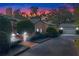Evening view of a house with a garage and landscaping, illuminated by lights at 2300 N Scenic Hwy # 37, Lake Wales, FL 33853