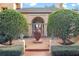 Elegant home entry with arched doorway, brick pavers, and lush landscaping at 2300 N Scenic Hwy # 37, Lake Wales, FL 33853