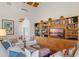 Living area with built-in shelving, comfortable seating, and large TV at 2300 N Scenic Hwy # 37, Lake Wales, FL 33853