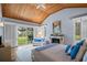 Main bedroom with wood ceilings, fireplace and backyard access at 2300 N Scenic Hwy # 37, Lake Wales, FL 33853