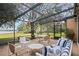 Relaxing screened patio overlooking lake with seating and table at 2300 N Scenic Hwy # 37, Lake Wales, FL 33853