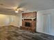 Living room featuring a brick fireplace and ceiling fan at 2314 York Pl, Lakeland, FL 33810