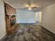 Living room with a brick fireplace and tile flooring at 2314 York Pl, Lakeland, FL 33810