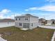 Two story house with backyard, solar panels, and fence at 245 Hillcrest Dr, Dundee, FL 33838