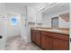 Bathroom with double vanity, shower, and tile flooring at 245 Hillcrest Dr, Dundee, FL 33838