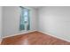 Bright bedroom with wood flooring and teal curtains at 245 Hillcrest Dr, Dundee, FL 33838