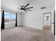 Large bedroom with carpet, ceiling fan and access to bathroom at 245 Hillcrest Dr, Dundee, FL 33838