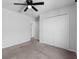 Bedroom with ceiling fan and double door closet at 245 Hillcrest Dr, Dundee, FL 33838