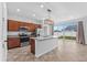 Modern kitchen with island, stainless steel appliances, and sliding doors at 245 Hillcrest Dr, Dundee, FL 33838