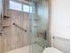 Updated bathroom with a walk-in shower, grab bars, and built-in seat at 2683 Wyndsor Oaks Way, Winter Haven, FL 33884
