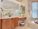 Bright bathroom with double sinks and a large mirror at 2683 Wyndsor Oaks Way, Winter Haven, FL 33884
