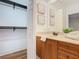 Bathroom with vanity, large mirror, and walk-in closet at 2683 Wyndsor Oaks Way, Winter Haven, FL 33884