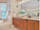 Bathroom with wood cabinets and a large vanity at 2683 Wyndsor Oaks Way, Winter Haven, FL 33884
