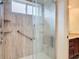 Walk-in shower with grab bars and neutral tile at 2683 Wyndsor Oaks Way, Winter Haven, FL 33884