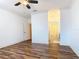 Spacious bedroom with wood-look flooring and access to a bathroom at 2683 Wyndsor Oaks Way, Winter Haven, FL 33884