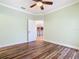 Bedroom with wood-look flooring and access to upper floor at 2683 Wyndsor Oaks Way, Winter Haven, FL 33884