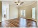 Bright bedroom with wood-look flooring, french doors, and ceiling fan at 2683 Wyndsor Oaks Way, Winter Haven, FL 33884