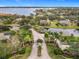 Grand entrance to the community with lush landscaping and a lake view at 2683 Wyndsor Oaks Way, Winter Haven, FL 33884