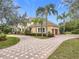 Stunning two-story home with a circular driveway and beautifully landscaped grounds at 2683 Wyndsor Oaks Way, Winter Haven, FL 33884