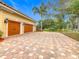 Two-car garage with paver driveway, offering ample parking and storage at 2683 Wyndsor Oaks Way, Winter Haven, FL 33884