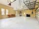 Spacious garage with overhead storage and ample room for multiple vehicles at 2683 Wyndsor Oaks Way, Winter Haven, FL 33884
