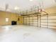 Spacious garage interior with overhead storage and extra space for organization at 2683 Wyndsor Oaks Way, Winter Haven, FL 33884