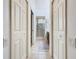 Clean hallway with light-colored walls and doors leading to bathrooms at 2683 Wyndsor Oaks Way, Winter Haven, FL 33884