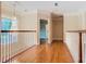 Upstairs hallway with hardwood floors and chandelier at 2683 Wyndsor Oaks Way, Winter Haven, FL 33884