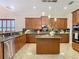 Spacious kitchen with granite countertops, island, and stainless steel appliances at 2683 Wyndsor Oaks Way, Winter Haven, FL 33884