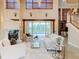 Bright living room with high ceilings, fireplace, and view of the pool at 2683 Wyndsor Oaks Way, Winter Haven, FL 33884