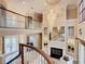 Two-story living room with a fireplace and chandelier at 2683 Wyndsor Oaks Way, Winter Haven, FL 33884