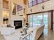 Open living space with fireplace, high ceilings, and access to the pool at 2683 Wyndsor Oaks Way, Winter Haven, FL 33884
