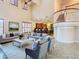 Open living area with a view of the kitchen and staircase at 2683 Wyndsor Oaks Way, Winter Haven, FL 33884